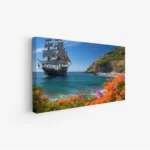 لوحة بحرية لسفينة شراعية تبحر في مياه زرقاء صافية محاطة بأزهار ملونة وجبال خضراء، لوحات طبيعة، لوحات كانفاس.